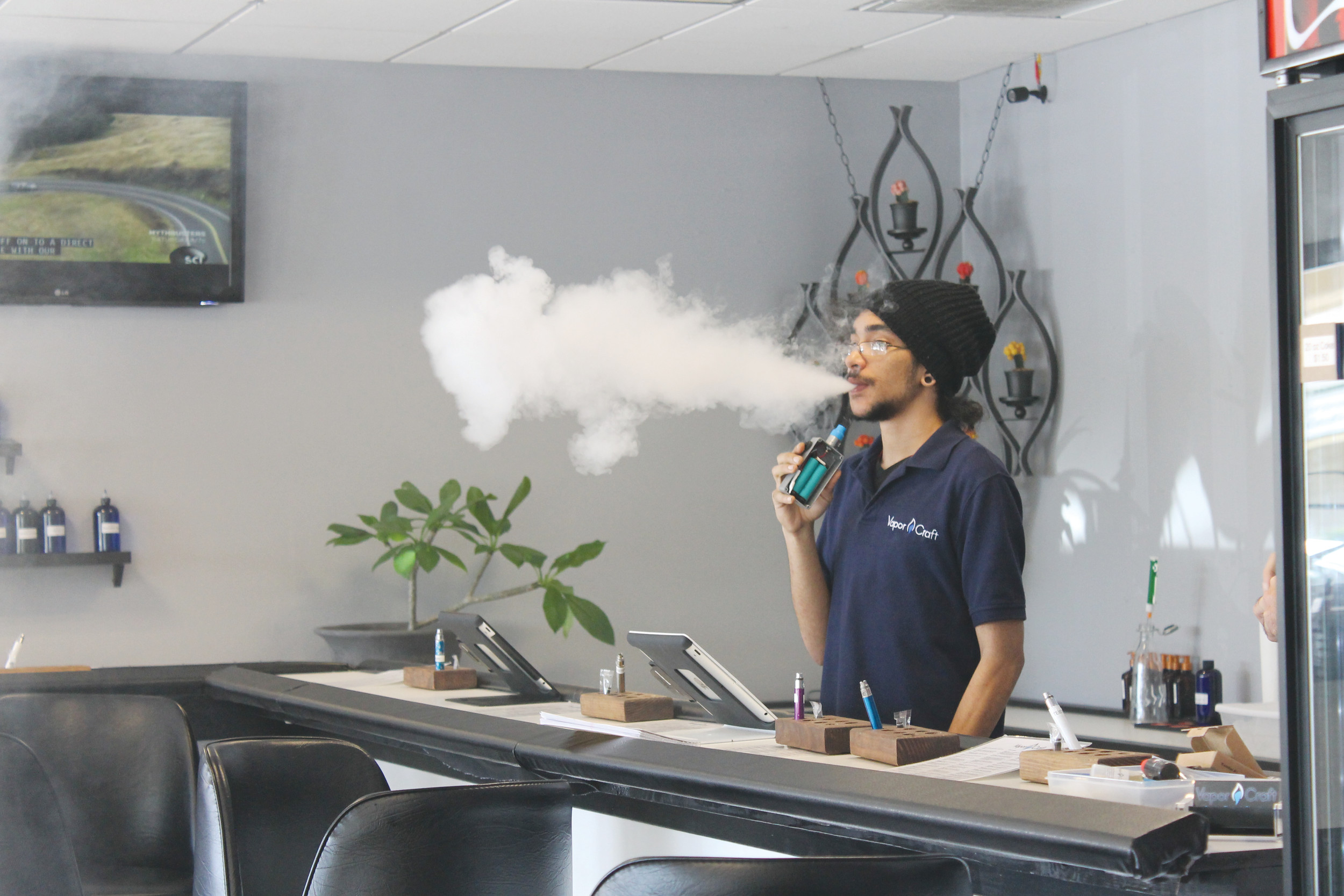 An employee of Vapor Craft on Wells Road in Orange Park demonstrates here how e-cigarettes work. A bill moving through the Florida Legislature would ban e-cigarettes everywhere tobacco cigarettes are currently banned in Florida.