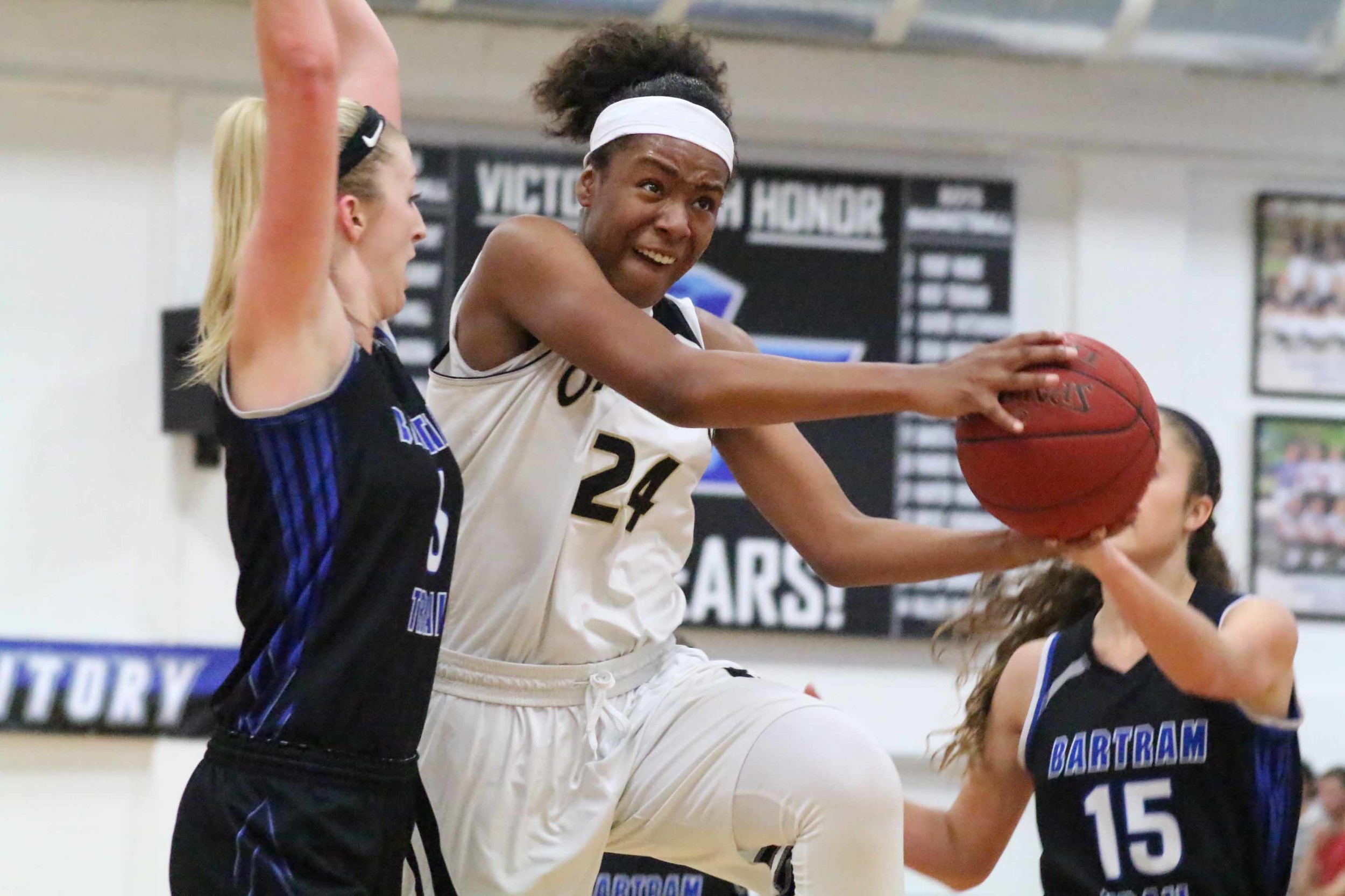 Oakleaf High senior center Jade Lewis powers for points in key district game against Bartram Trail. Lewis heads to the University of Miami in the fall.