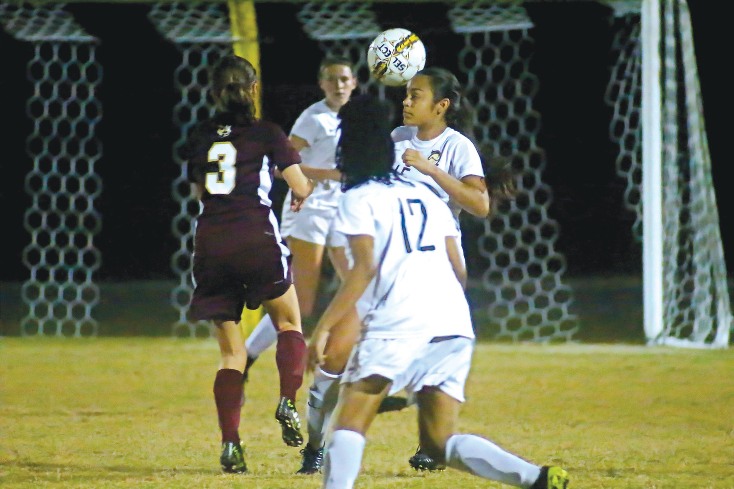 Oakleaf defender Brianna Olazabal gets a head on loose ball in front of Knights’ net.