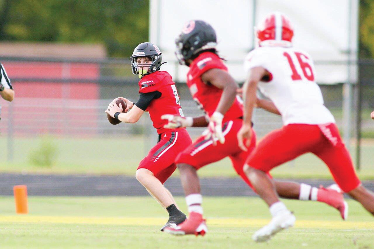 Middleburg quarterback Carson Stewart looks downfield for a target against Bradford County.